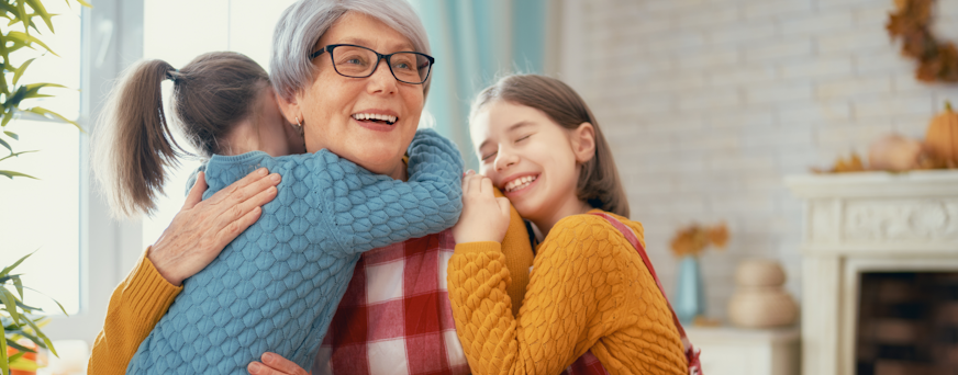 Life Assure Senior Woman Sitting In Chair And Laughing With Caregiver Nurse Hero